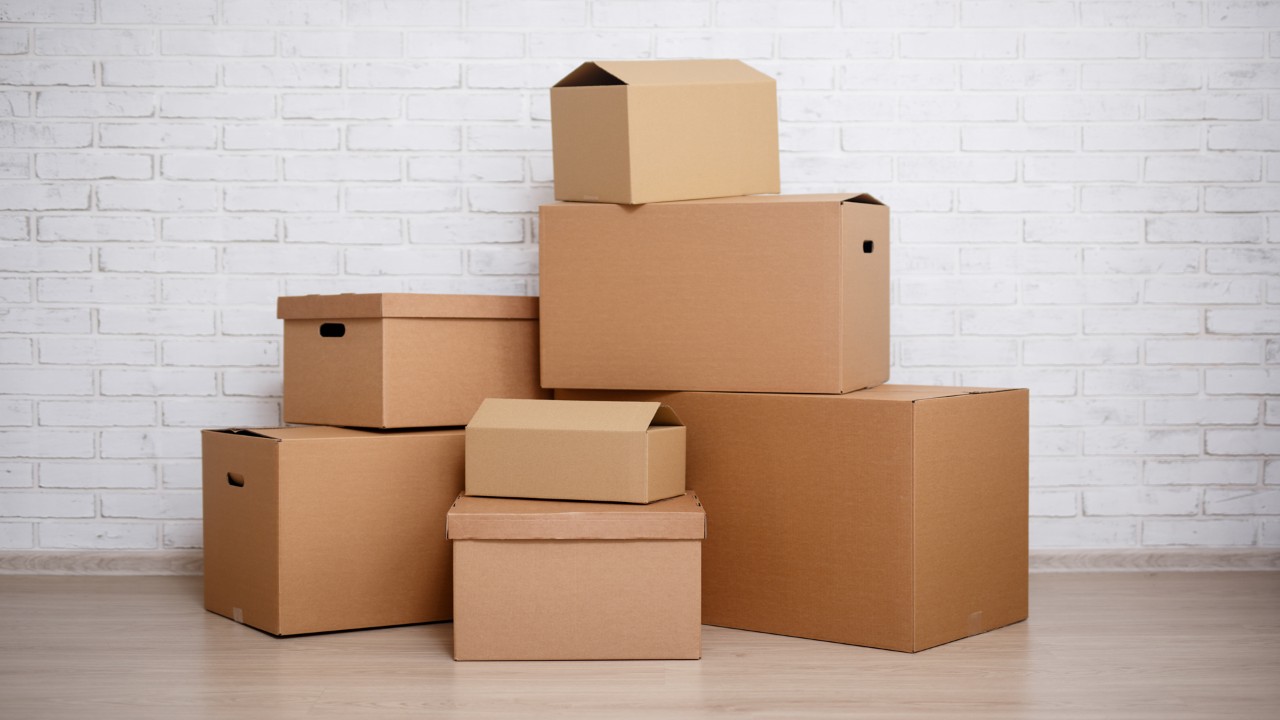 cardboard boxes over white brick wall background